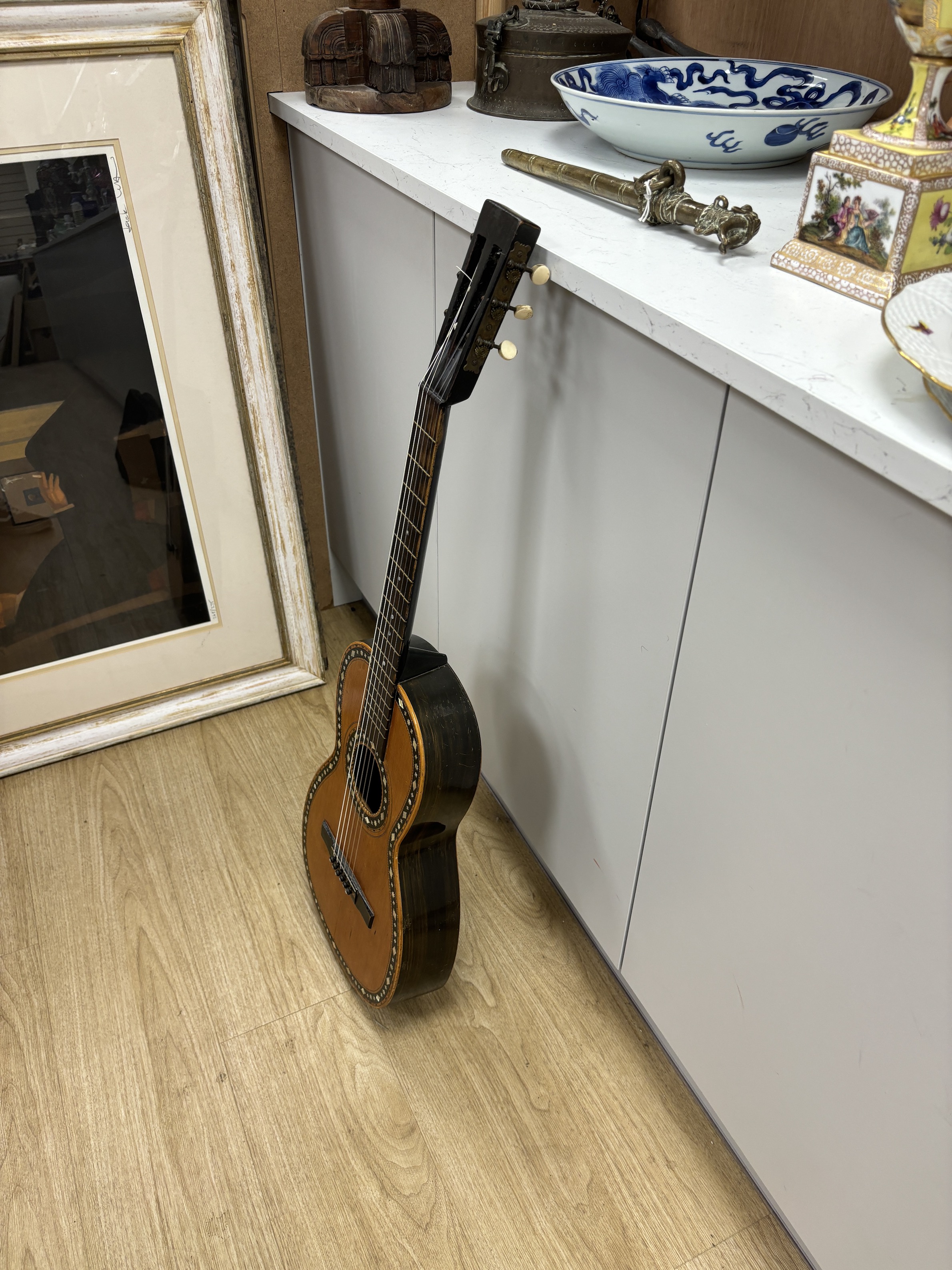 A mid-19th century Continental six string parlour guitar, soundboard inlaid with mother of pearl, rosewood back, length of body 45.5cm, overall length 92cm